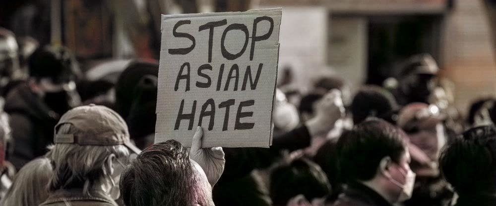 Protester holding sign that says "Stop Asian Hate"