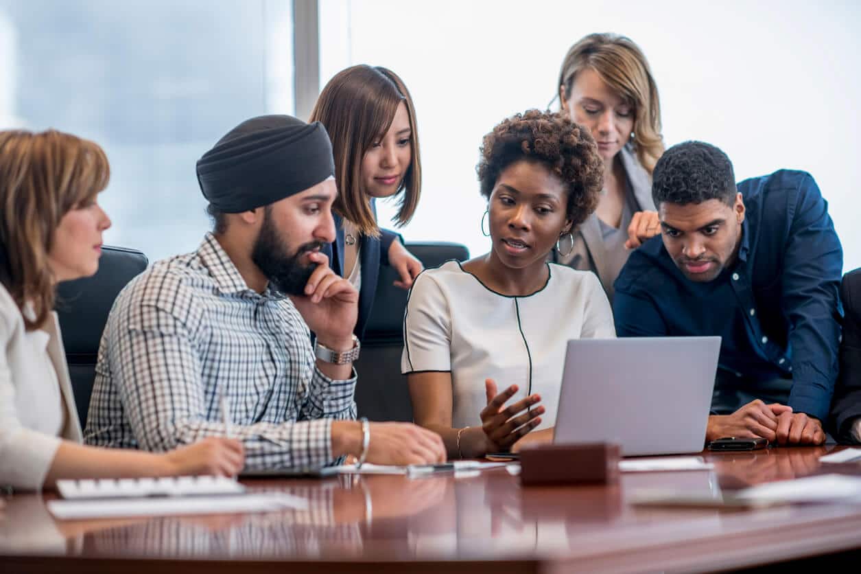 6 Diverse Employees Looking at a Laptop Screen