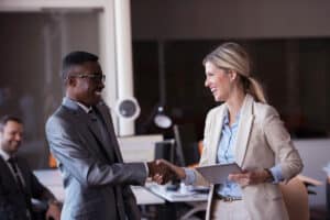 Business professionals shaking hands at the office